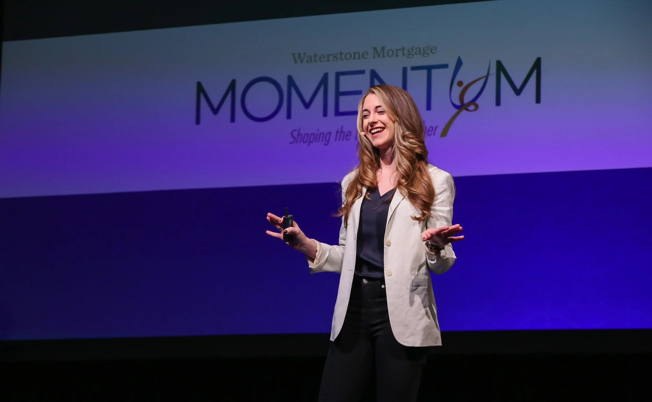 Kristin Messerli, on stage, white blazer
